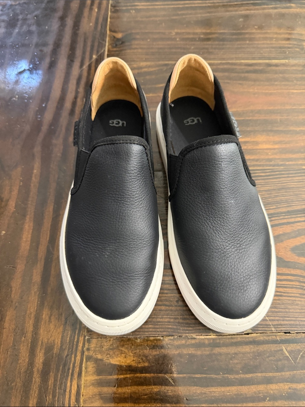 UGG Women’s Black Leather Slip-On Sneakers with White Sole